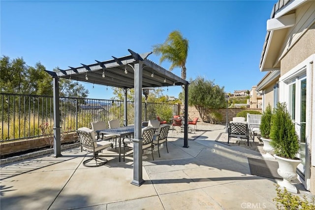 view of patio / terrace with outdoor dining area, a fenced backyard, and a pergola