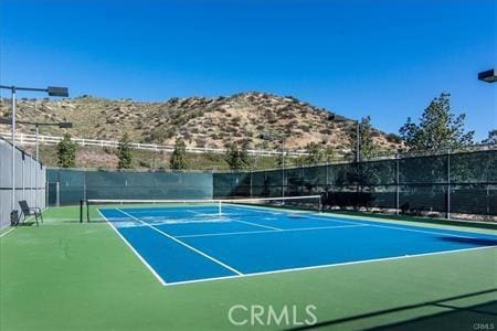 view of tennis court with fence