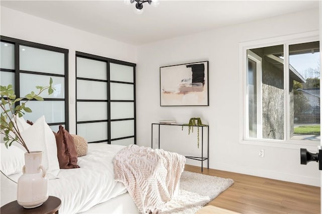 bedroom with wood finished floors and baseboards