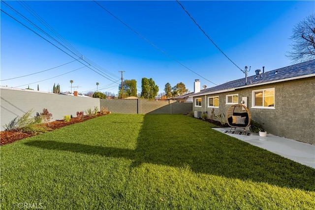 view of yard featuring a patio and a fenced backyard