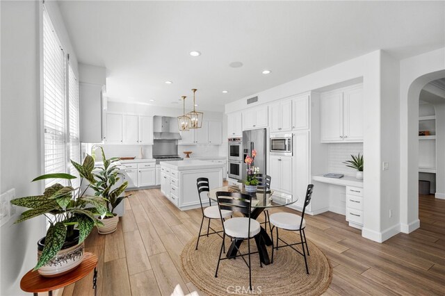 106 Via Sabinas, San Clemente, CA 92673 - dining area with light wood-style floors, arched walkways, recessed lighting, a chandelier, and baseboards