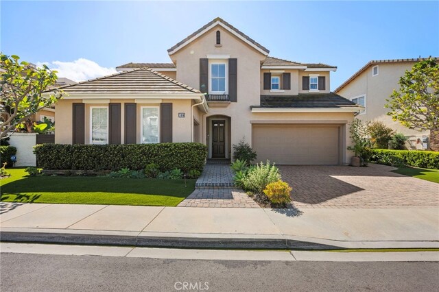 106 Via Sabinas, San Clemente, CA 92673 - traditional-style house featuring a garage, stucco siding, driveway, a front yard, and a tiled roof