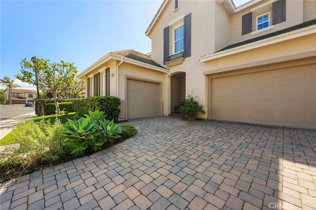 106 Via Sabinas, San Clemente, CA 92673 - view of front of house with stucco siding, decorative driveway, and a garage