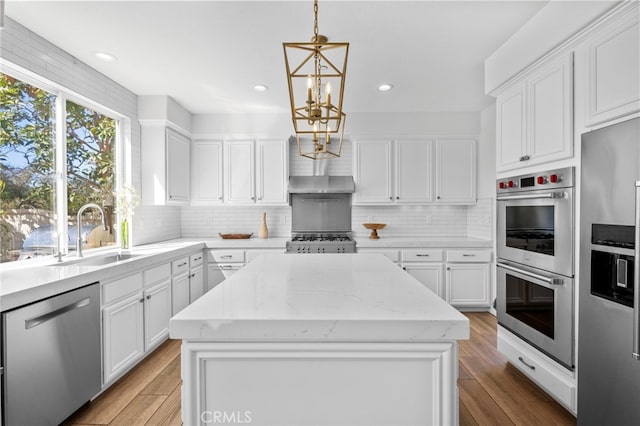 106 Via Sabinas, San Clemente, CA 92673 - kitchen with stainless steel appliances, a chandelier, a sink, a kitchen island, and white cabinets