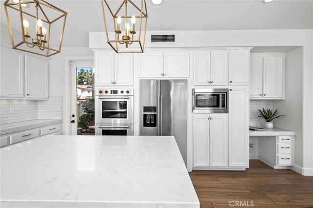 106 Via Sabinas, San Clemente, CA 92673 - kitchen with a chandelier, stainless steel appliances, tasteful backsplash, white cabinetry, and recessed lighting