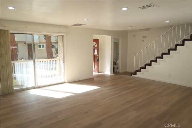 interior space featuring stairs, visible vents, and wood finished floors