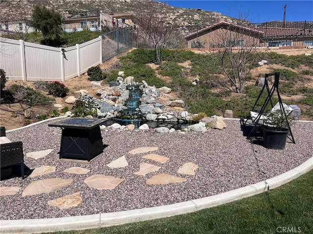 view of yard with a fire pit and a fenced backyard