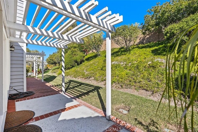 view of patio with a pergola and fence