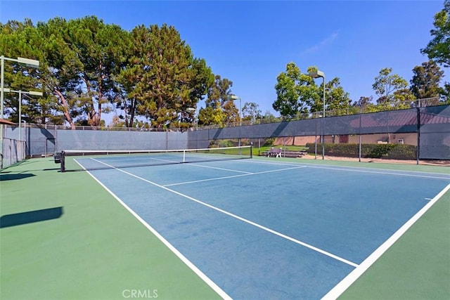 view of tennis court with fence