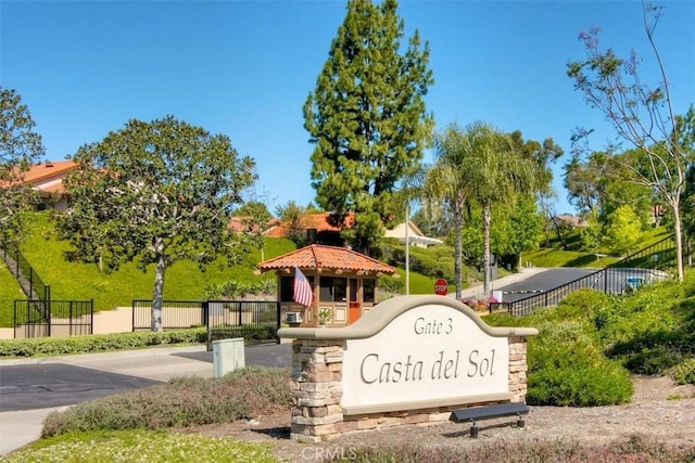 community sign featuring fence