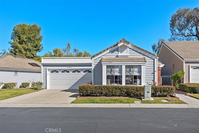 ranch-style house with concrete driveway and an attached garage