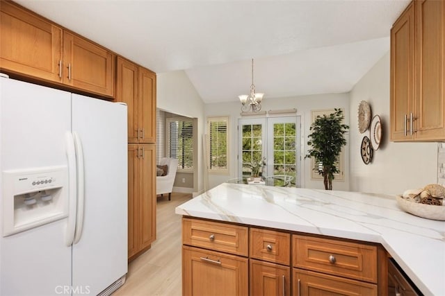 kitchen with brown cabinets, white refrigerator with ice dispenser, a peninsula, light wood finished floors, and vaulted ceiling