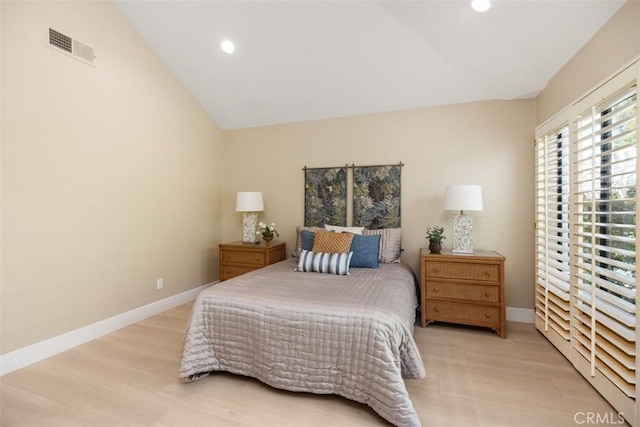 bedroom featuring visible vents, recessed lighting, light wood finished floors, baseboards, and vaulted ceiling