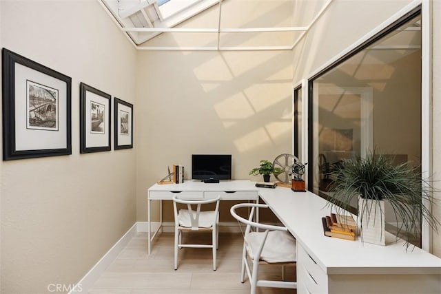 office area with a skylight and baseboards