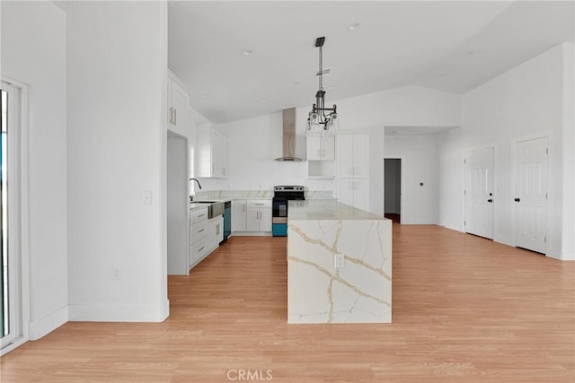 kitchen featuring electric range, white cabinetry, light wood-type flooring, light stone countertops, and wall chimney exhaust hood