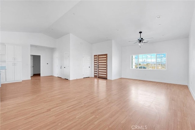 unfurnished living room featuring vaulted ceiling, light wood-type flooring, and a ceiling fan