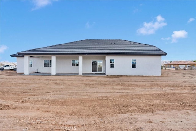 back of house featuring stucco siding