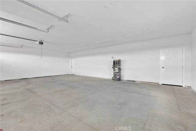 garage featuring water heater and a garage door opener