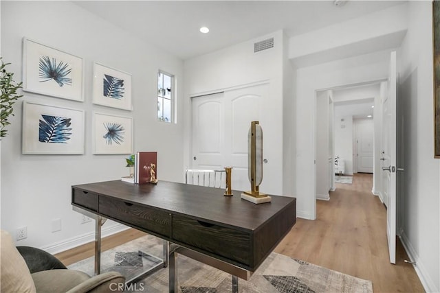 office featuring recessed lighting, visible vents, light wood-style flooring, and baseboards