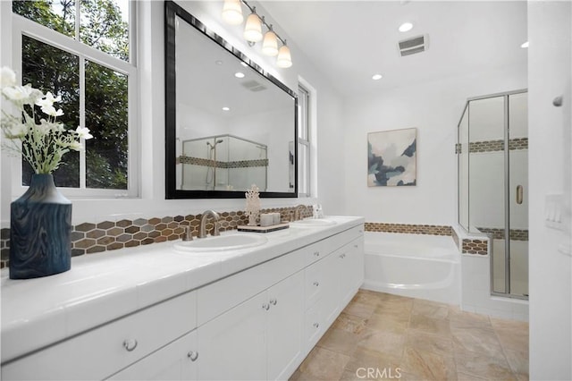 full bath with a sink, visible vents, a bath, and a shower stall