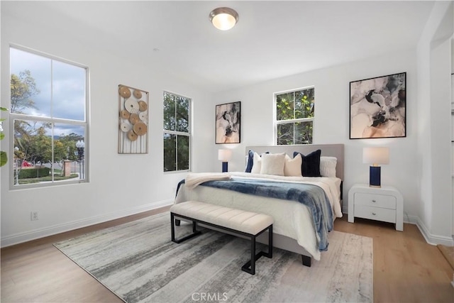 bedroom featuring wood finished floors and baseboards