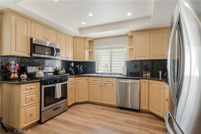 kitchen featuring open shelves, light brown cabinets, stainless steel appliances, and a raised ceiling