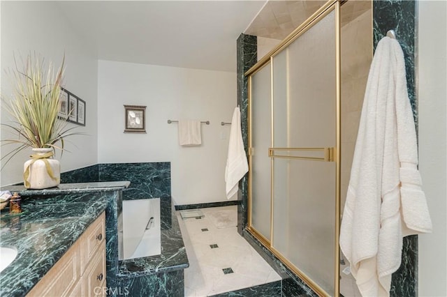 bathroom with a stall shower, a bath, and vanity