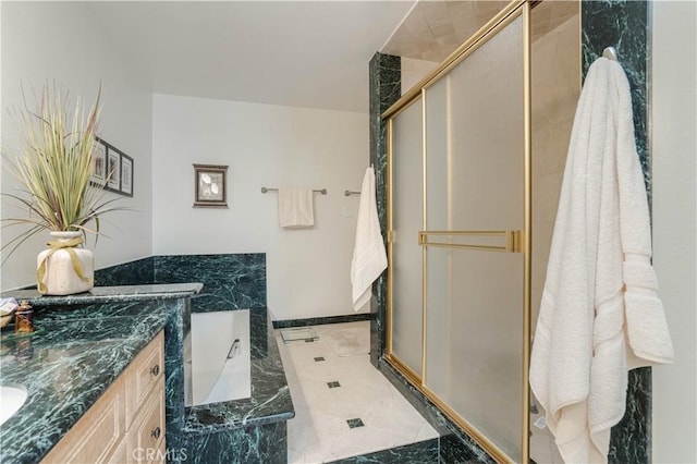 full bath with a garden tub, vanity, and a stall shower
