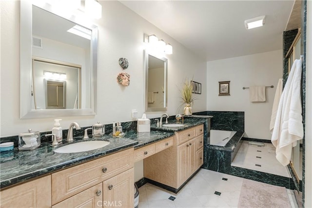 full bath with a garden tub, visible vents, a sink, and double vanity