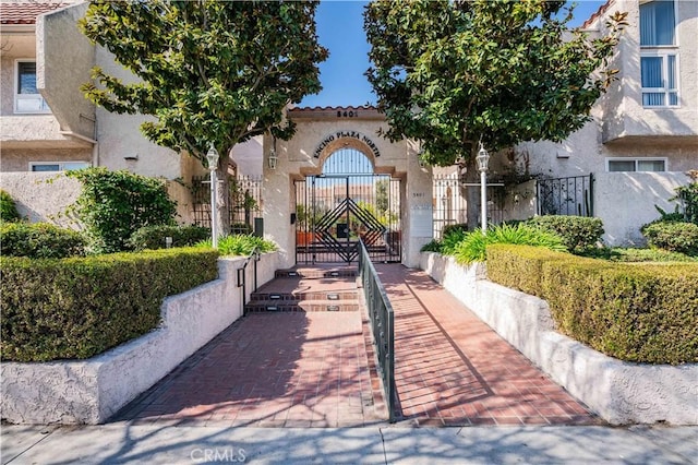 view of property's community featuring a gate and fence