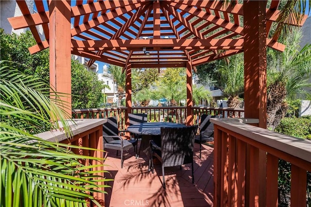 wooden deck with outdoor dining area and a pergola