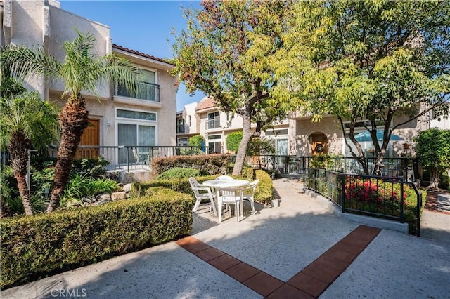 view of community featuring a patio area and outdoor dining space