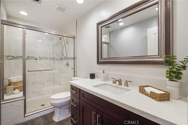 full bathroom with a marble finish shower, visible vents, vanity, and toilet