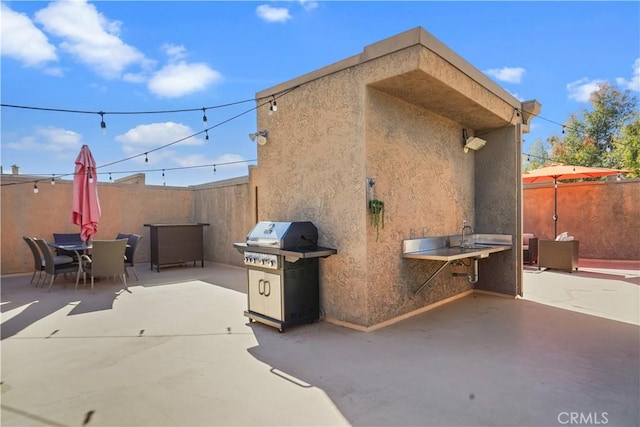 view of patio / terrace with outdoor dining space, fence, and area for grilling