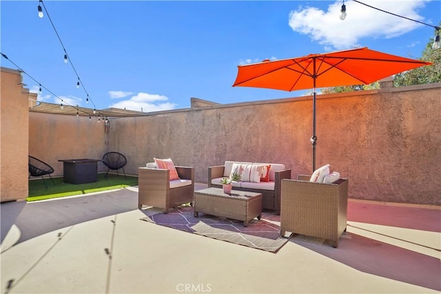 view of patio / terrace with an outdoor hangout area and fence