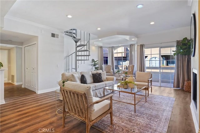 living room with baseboards, stairs, visible vents, and wood finished floors