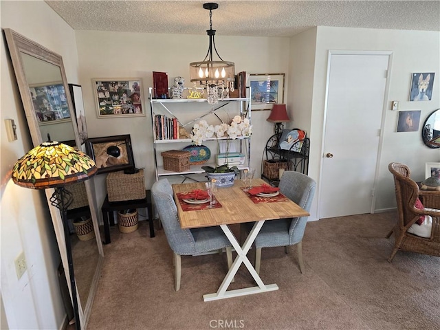 carpeted dining space with a notable chandelier and a textured ceiling