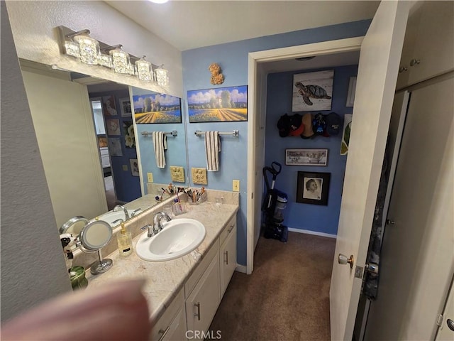 bathroom with baseboards and vanity