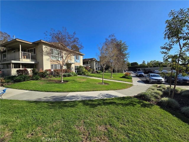 view of home's community featuring a lawn