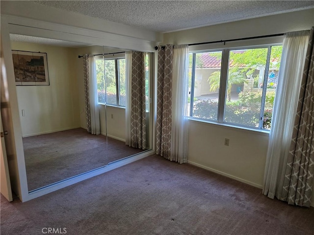 784 Via Los Altos Unit A, Laguna Woods, CA 92637 - spare room with carpet floors, a textured ceiling, baseboards, and a wealth of natural light