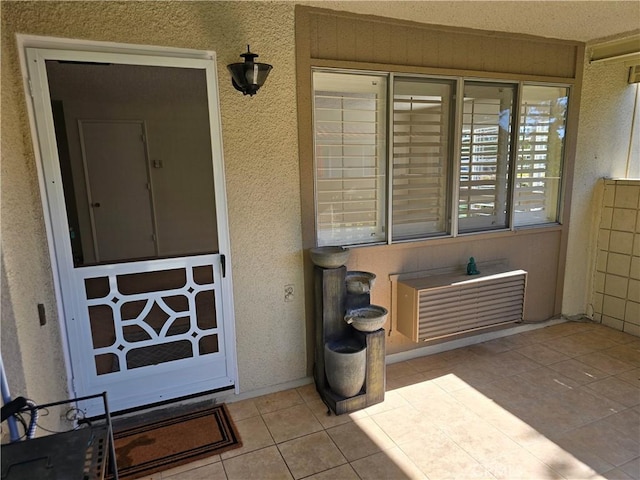 entrance to property featuring stucco siding