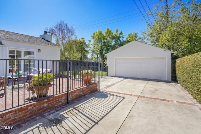 detached garage featuring fence