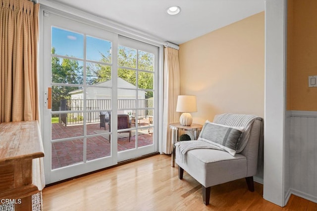 sitting room featuring recessed lighting, wood finished floors, and a wainscoted wall