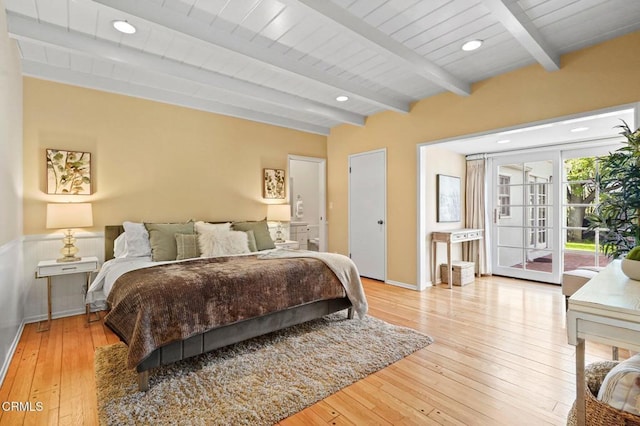 bedroom with access to exterior, beamed ceiling, light wood-style flooring, and recessed lighting