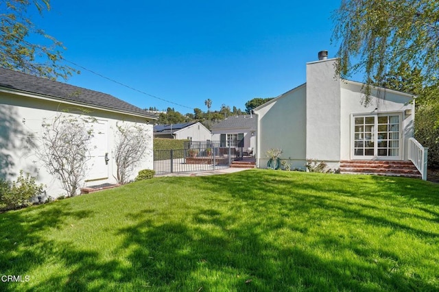 view of yard with fence and entry steps