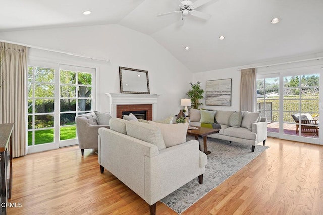 living area with plenty of natural light, a fireplace, recessed lighting, and light wood finished floors