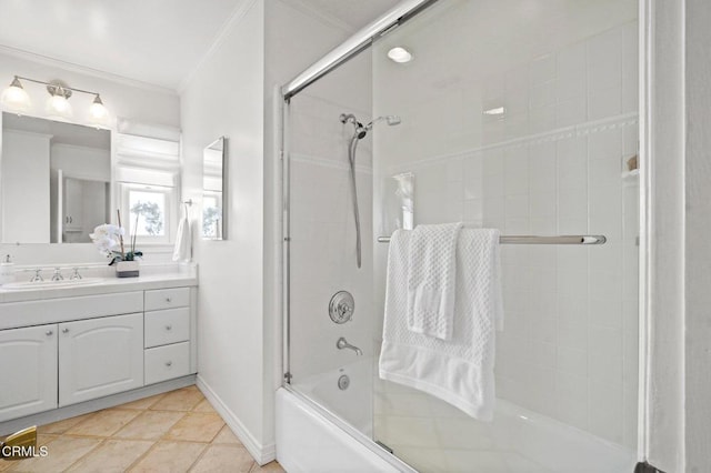 full bath featuring enclosed tub / shower combo, crown molding, tile patterned flooring, baseboards, and vanity