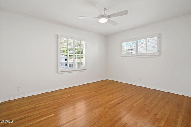 unfurnished room with baseboards, light wood-style flooring, a ceiling fan, and ornamental molding