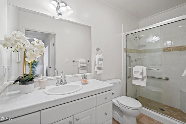 bathroom with vanity, toilet, ornamental molding, and a shower stall