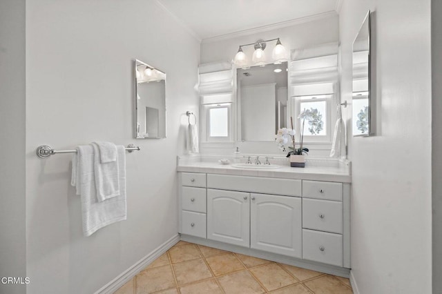 bathroom with tile patterned flooring, vanity, crown molding, and baseboards